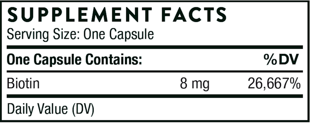 Hand holding a Thorne Biotin-8 capsule to show small, easy-to-swallow vegetarian capsule size for daily B7 support.
